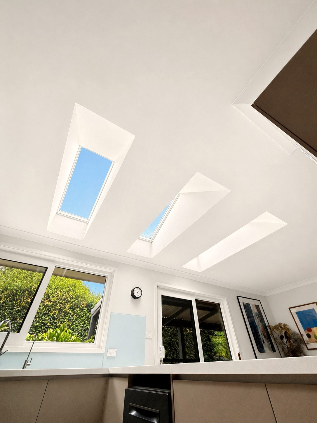 Three pyramid skylights pulling daylight into a Sydney kitchen