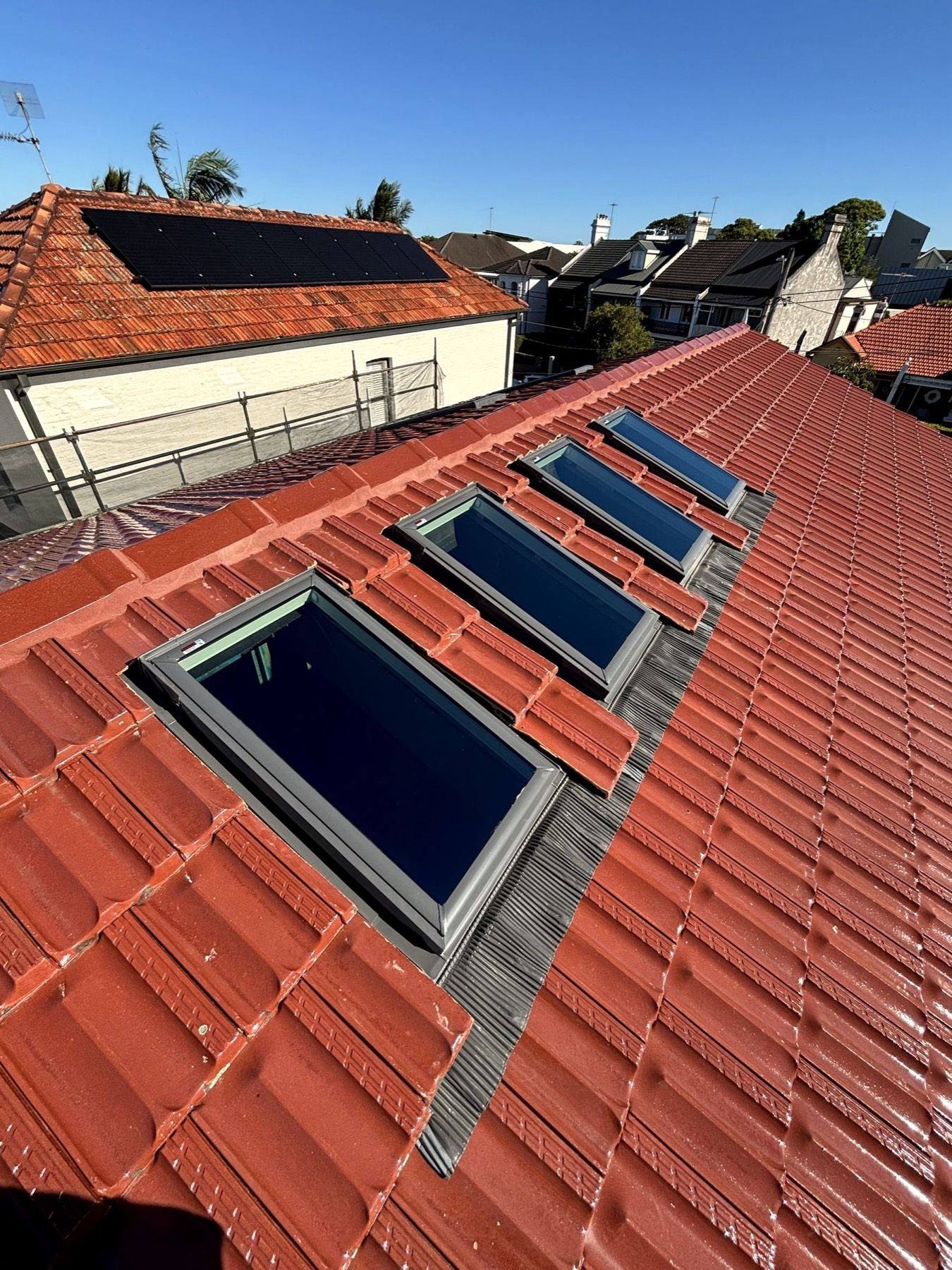 Four-skylight ridge run with custom flashing on terracotta tile